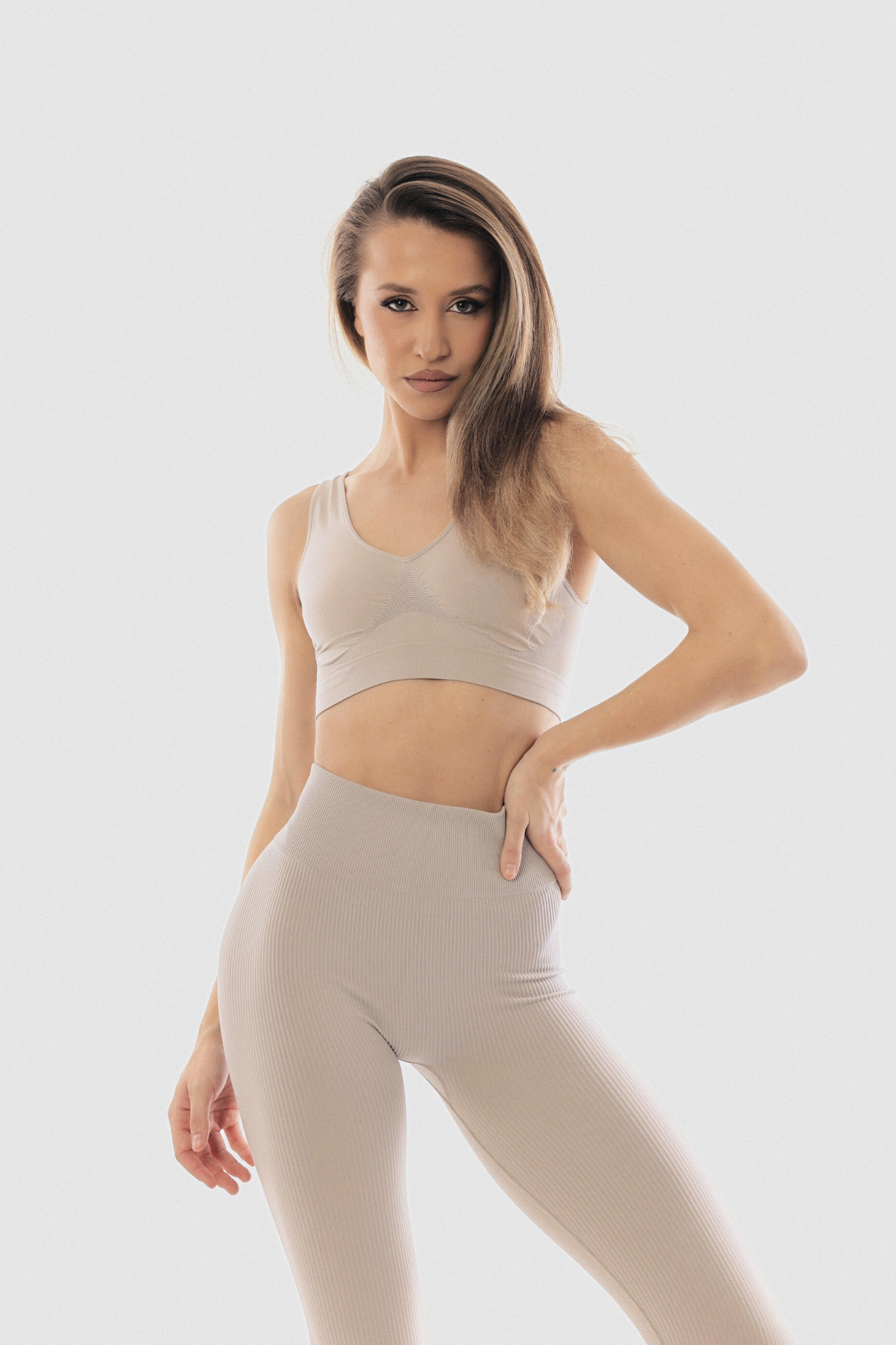 A beige wide strap top knit in seamless technique