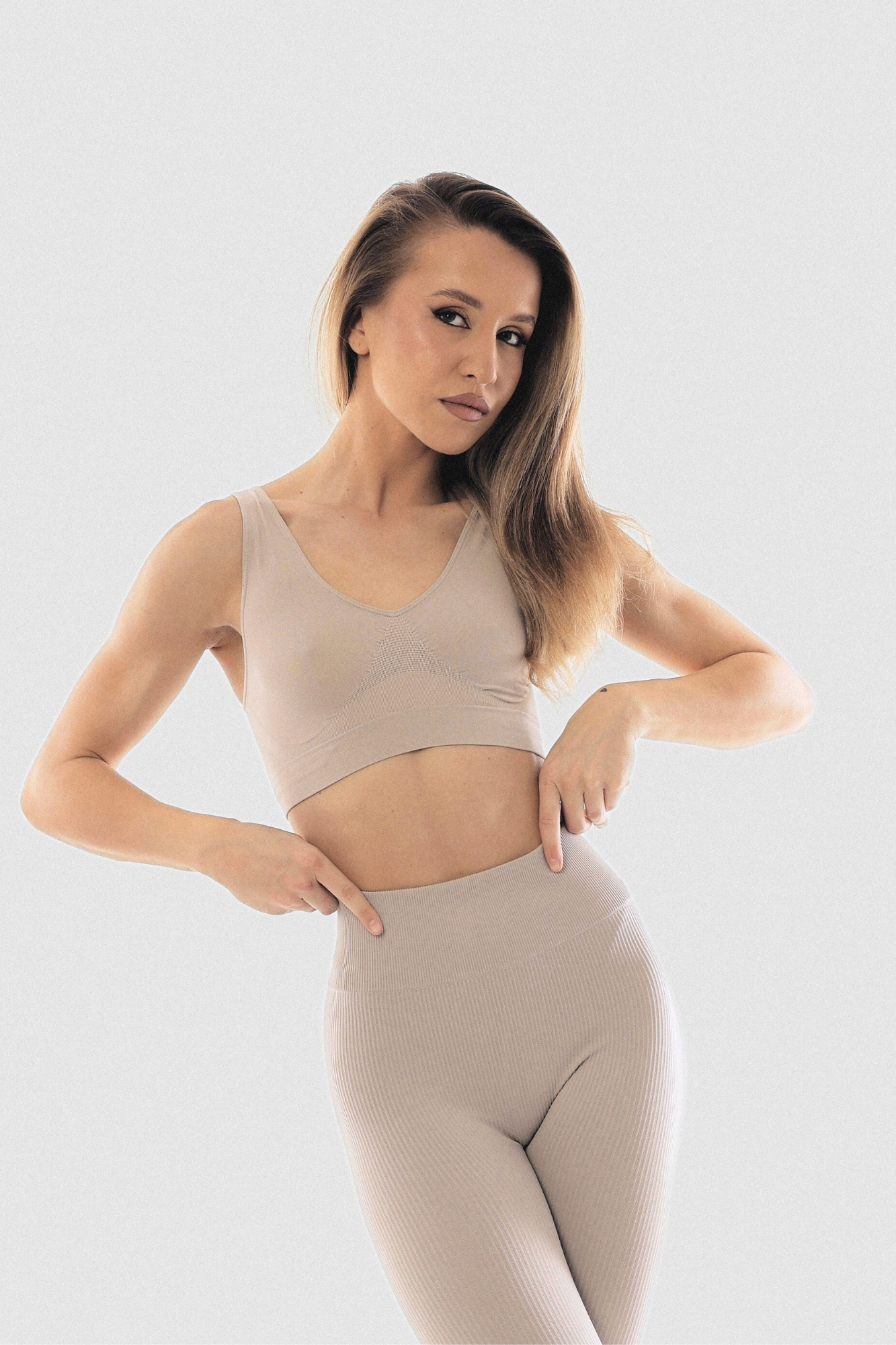 A beige wide strap top knit in seamless technique